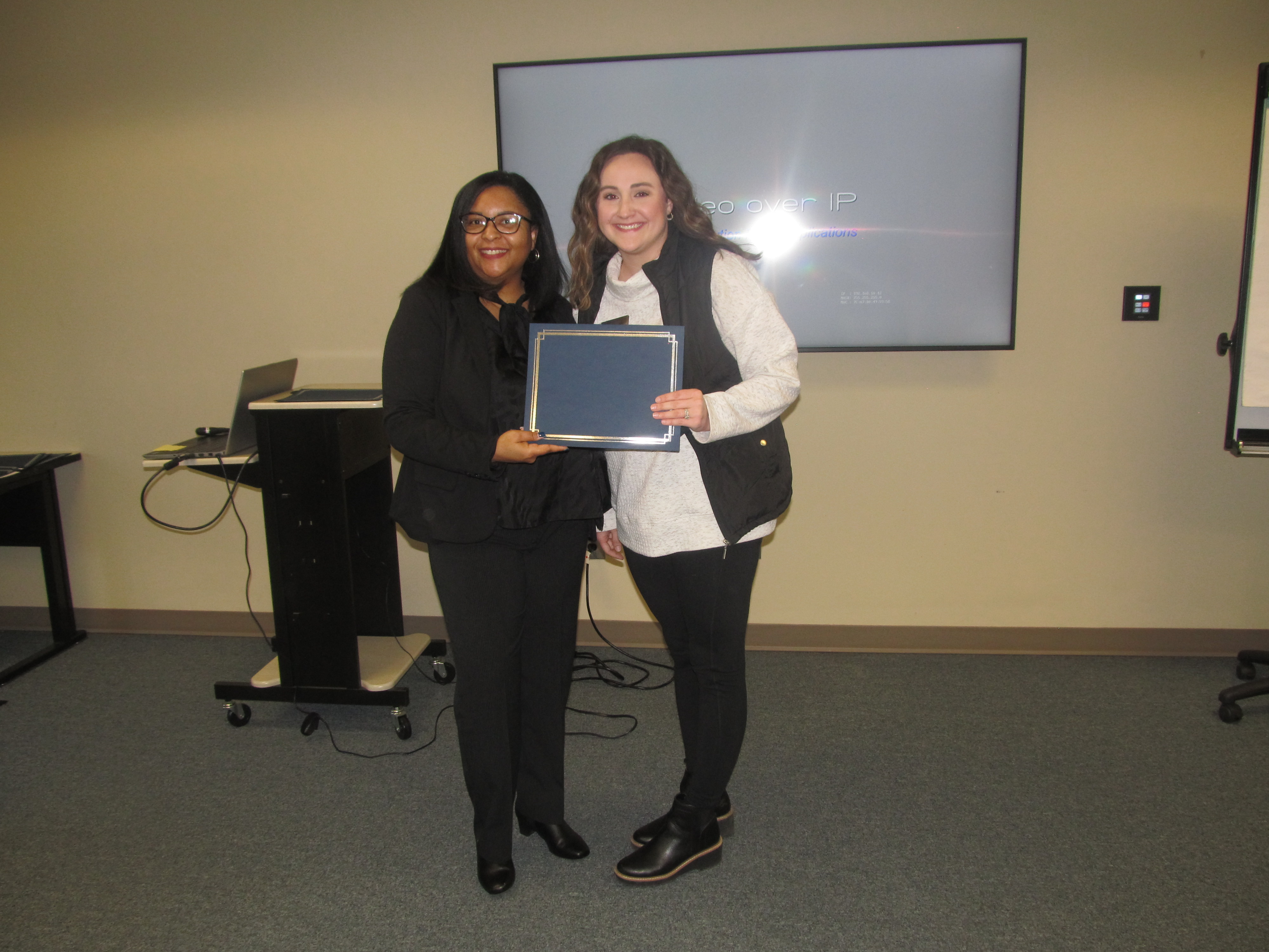 Attendee receiving certificate of completion 